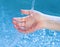 Kid\'s hand under stream of water