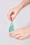 Kid`s hands holding a transparent green slime isolated