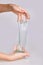 Kid`s hands holding a transparent green slime isolated