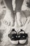 Kid\'s shoes and mom\'s feet.