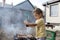 Kid seasoning pork chops with pepper