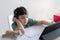 Kid self isolation using computor for his homework,Child using laptop searching information on internet while school off during