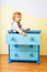 Kid sitting inside cabinet box