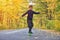 Kid skateboarder doing skateboard tricks in autumn environment