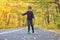 Kid skateboarder doing skateboard tricks in autumn environment