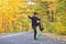 Kid skateboarder doing skateboard tricks in autumn environment