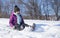 Kid on snow slides in winter time