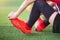 Kid soccer player is sitting and catch the soles of the feet because of pain, soccer player was injured in the foot with pain