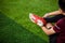 Kid soccer players is sitting with warming on green artificial turf for stretch muscles before and after play soccer game