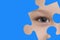 Kid spies through a blue puzzle. Symbol of autism awareness