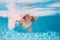 Kid swimming in pool underwater. Child boy swim under water in sea. Summer kids activity, watersports.