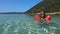 Kid Swimming in Sea Water on Beach, Child Playing on Seashore, Blonde Little Girl with Life Buoy Enjoying Waves on Coastline