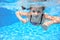 Kid swims in pool underwater, girl swimming