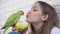 Kid Talk Parrot, Girl Playing her Pet, Young, Child Bird Eating Apple Fruit, Funny Indian Ring-Necked Parakeet Birds Cage Family