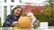 Kid and teacher preparing pumpkin for school party, additional handicraft class