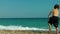 Kid throwing stone to the sea