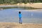 Kid throwing stone in water