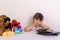 Kid tired because of too much information. Stressed little girl sitting near phones, smartphones, laptops, pc tablets.