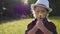 Kid tourist examines flower with a magnifying glass in the park. travel tourism adventure concept. little kid boyscout