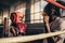 Kid training with his boxing coach inside a boxing ring