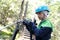 Kid using carabiner on training route to rope park