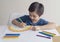 Kid using colour pen painting rainbow on paper,Child using digital tablet searching information on internet about rainbow color,