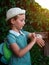 Kid using smartwatch outdoor. Child talking on the smartphone. Schoolgirl using touchscreen on watches browsing internet