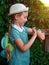 Kid using smartwatch outdoor. Child talking on the smartphone. Schoolgirl using touchscreen on watches browsing internet