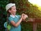 Kid using smartwatch outdoor. Child talking on the smartphone. Schoolgirl using touchscreen on watches browsing internet