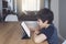 Kid using tablet  studying homework, Child using digital tablet for his online lesson at home during quarantine, Home schooling,