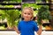 Kid with vegetables at grocery store. Child at vegetable supermarket. Little kid choosing food in store or grocery store