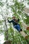 Kid walking on a logs path in adventure park