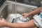 Kid washing dishware in the kitchen sink