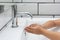 Kid washing hands with soap and water.