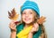 Kid wear warm knitted hat and long scarf. Fall fashion concept. Which fabrics will keep you warmest this autumn. Warm