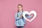 Kid with white heart on pink , St valentines day and mothers day concept