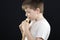 Kid in white playing panflute sideview