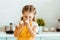 Kid in yellow polka dot apron looking at eggs in kitchen