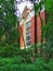 Kidder Hall, Oregon State University, arched window seen through trees.