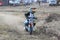 Kiddy motorbike rider speeding down track on mini motorbike.