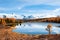 Kidelu lake in autumn forest and snow-covered mountains in Altai, Siberia, Russia