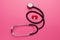Kidneys of human and stethoscope on pink background. Pain in the genitourinary system, treatment of kidney stones. Chronic and