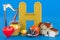 Kids ABC, fluffy letter H with home, heart, helmet, harp, honey. 3D rendering