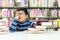 Kids asia boy reading books for education and go to school in library.