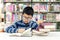 Kids asian boy reading books for education and go to school in library