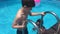 Kids bathe in the pool. children boy and girl swimming in the pool playing slow motion video water