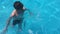Kids bathe in the pool. children boy and girl swimming water in the pool playing slow motion video