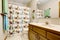 Kids bathroom interior with animal patterned curtain and green and blue towels.