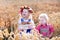 Kids in Bavarian costumes in wheat field