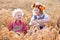 Kids in Bavarian costumes in wheat field